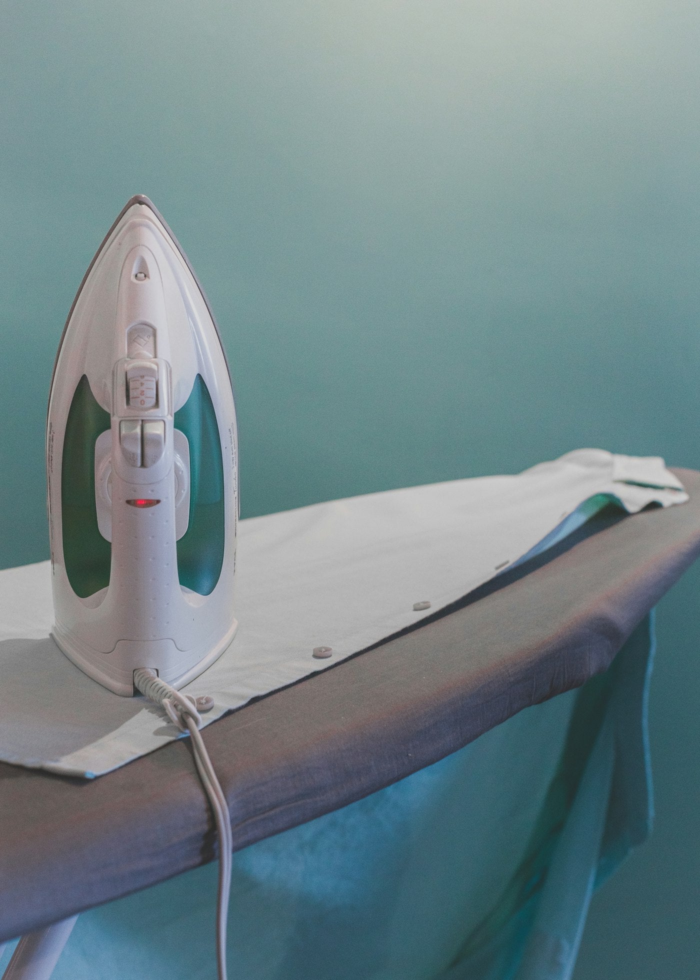 An iron on an ironing board
