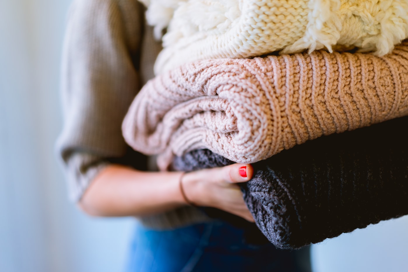 Folded knitwear held in both arms