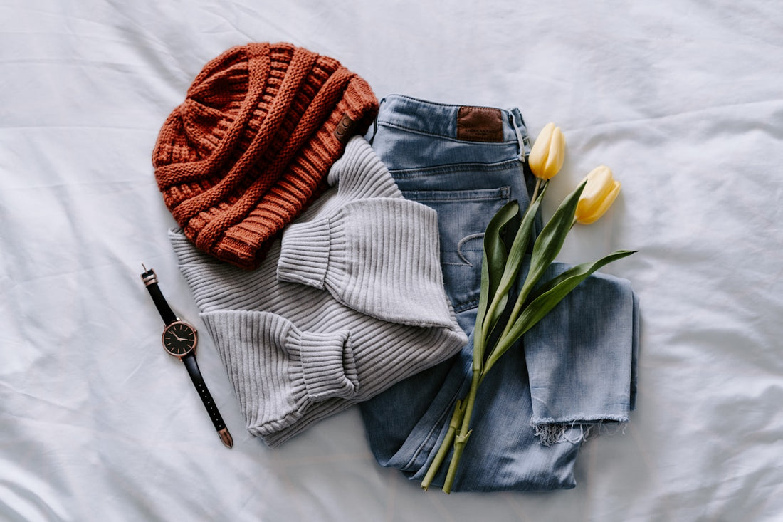 Autumn layering flat lay with knitwear and denim