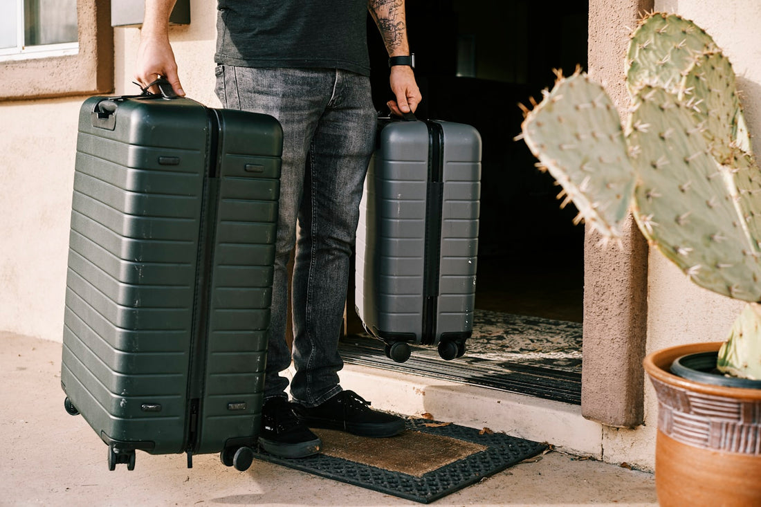 Two travellers with carry-on suitcases