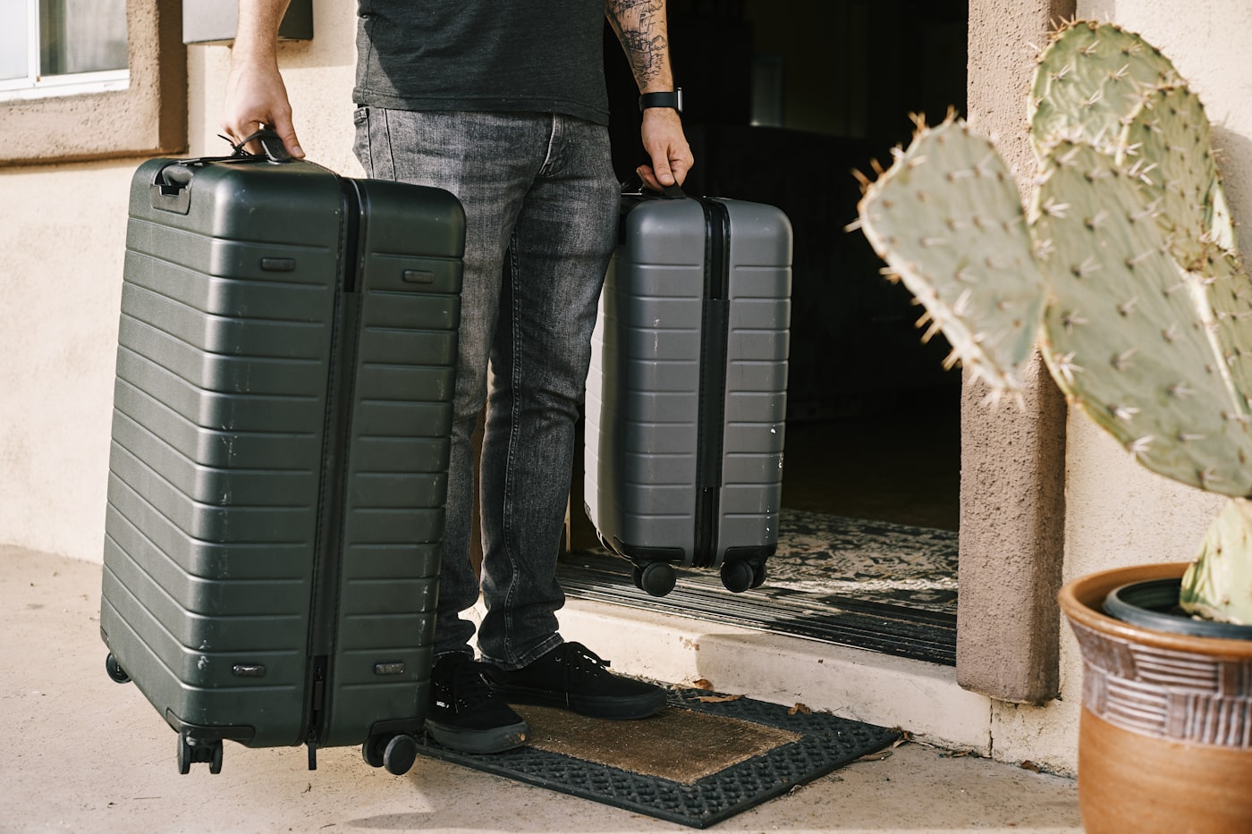 Two travellers with carry-on suitcases