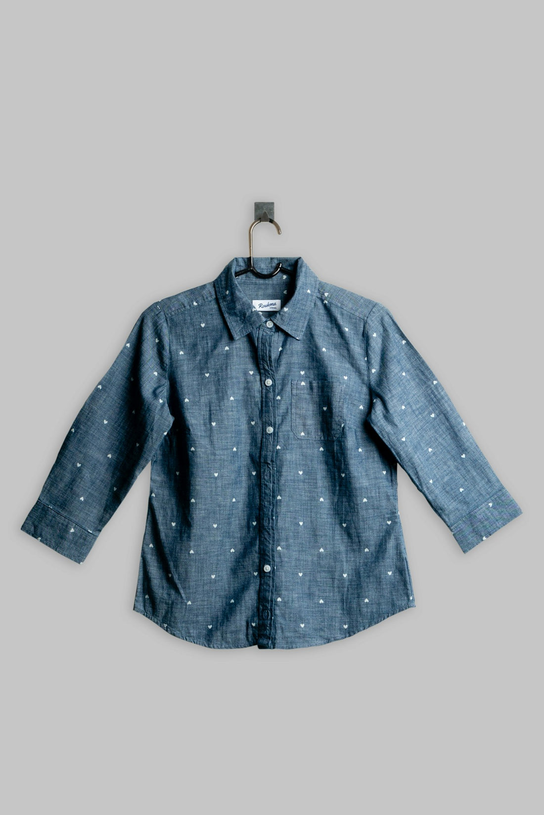 A chambray shirt hanging on a rail