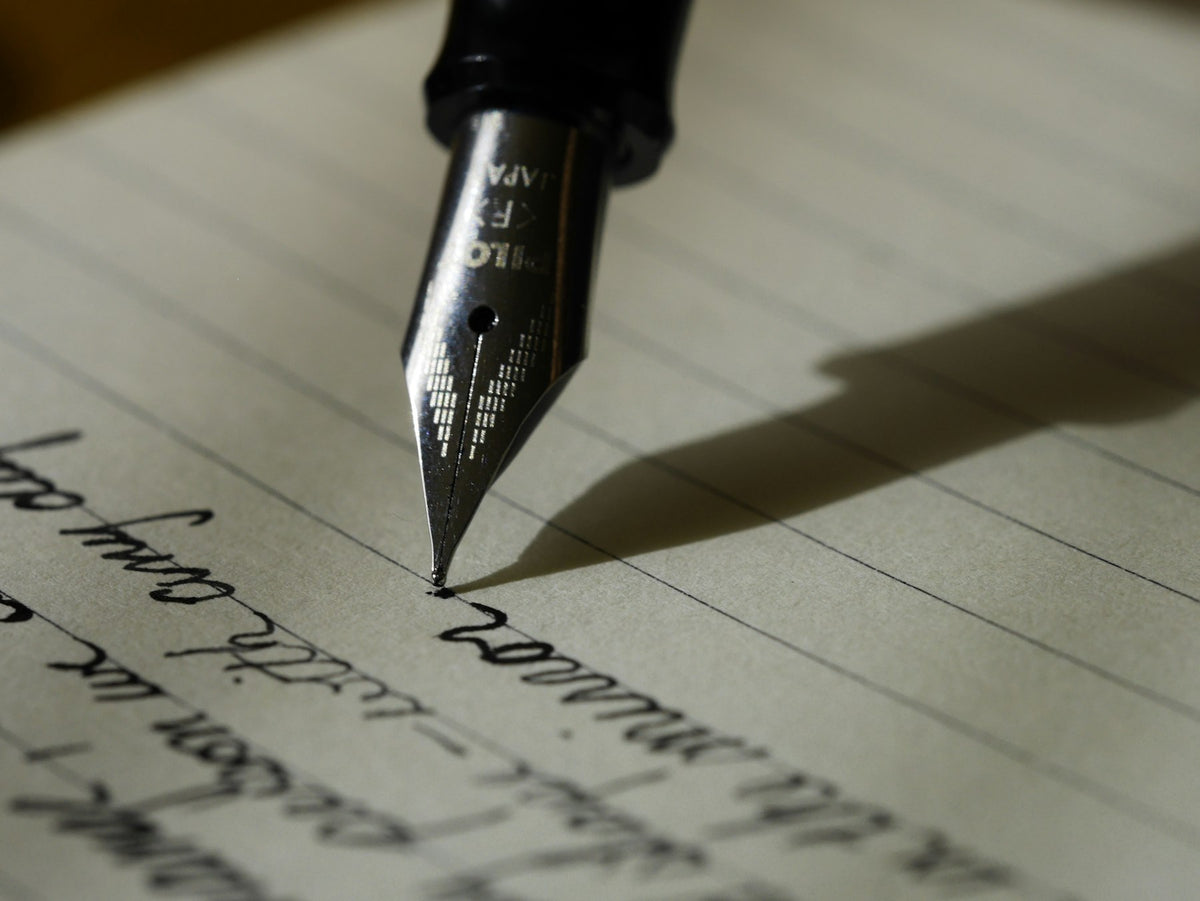 Fountain pen nib on written script