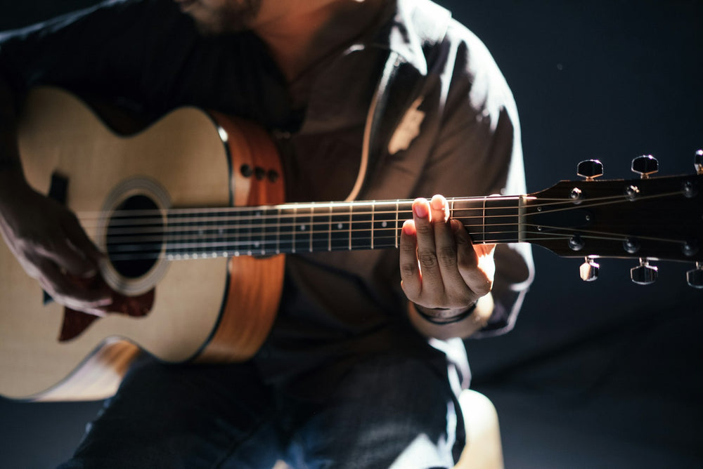 Guitarist playing in low light