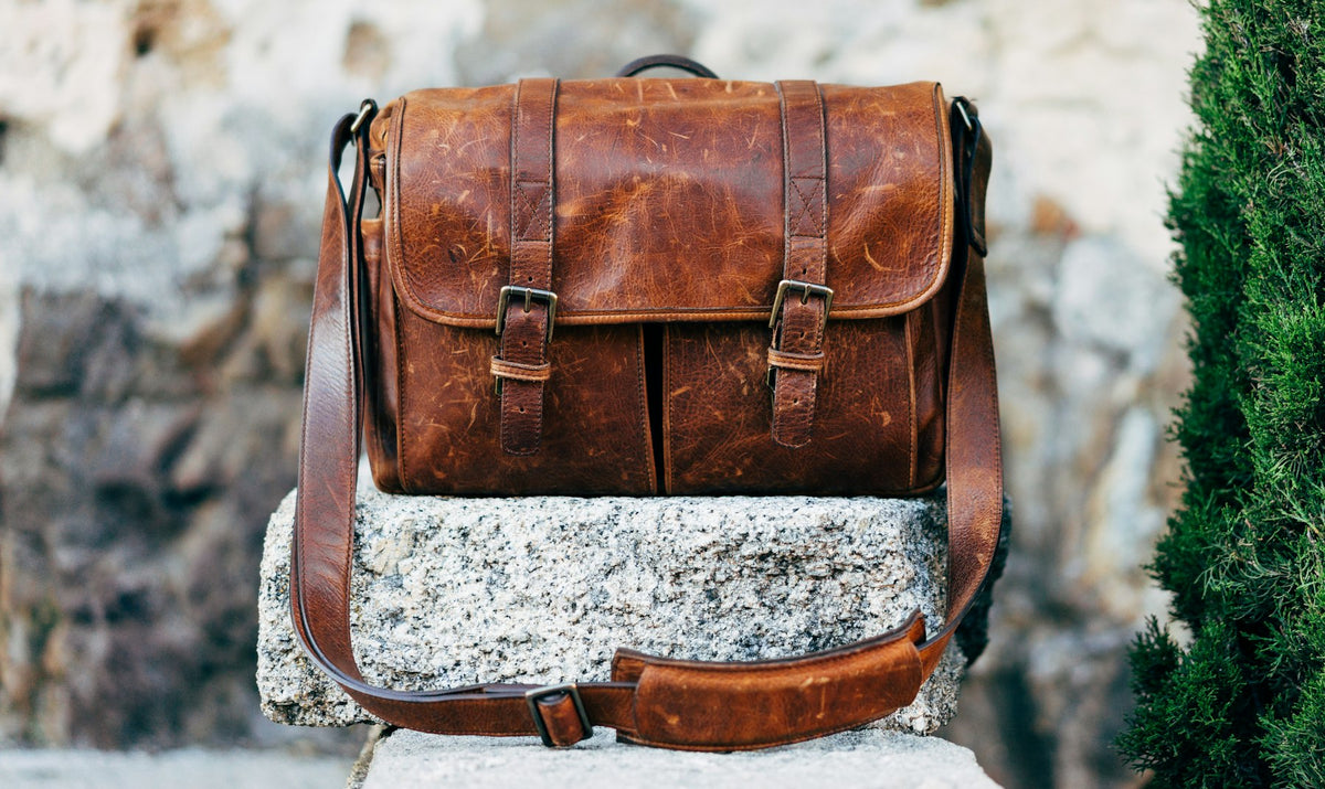 Worn leather satchel on stone