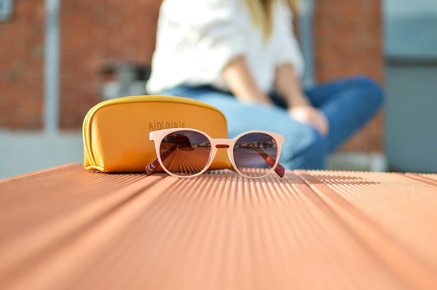 Sunglasses beside a yellow case