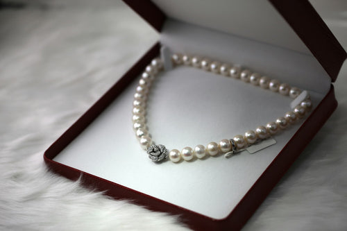 A freshwater pearl necklace resting in a presentation box