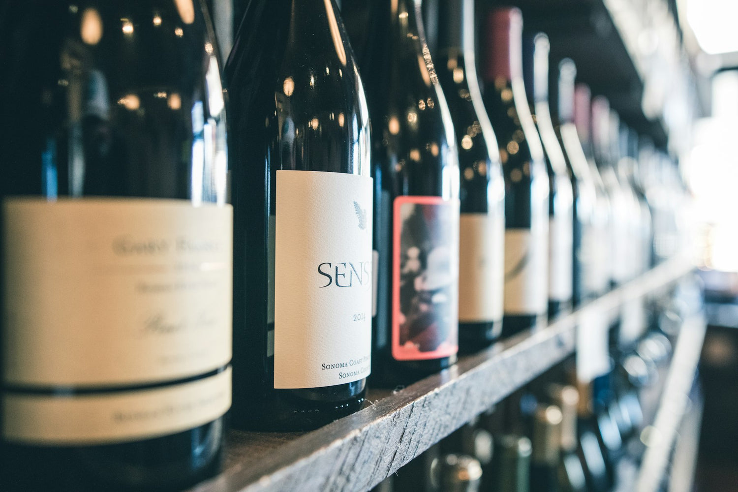 Wine bottles lined on a shelf