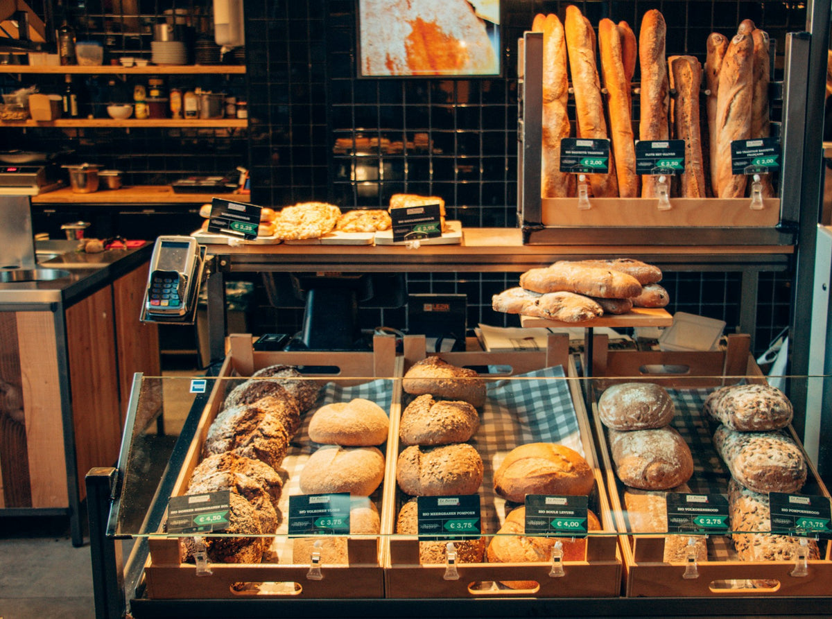 Bakery shelves stacked with bread