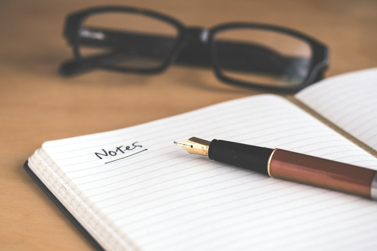 Notebook, fountain pen and glasses