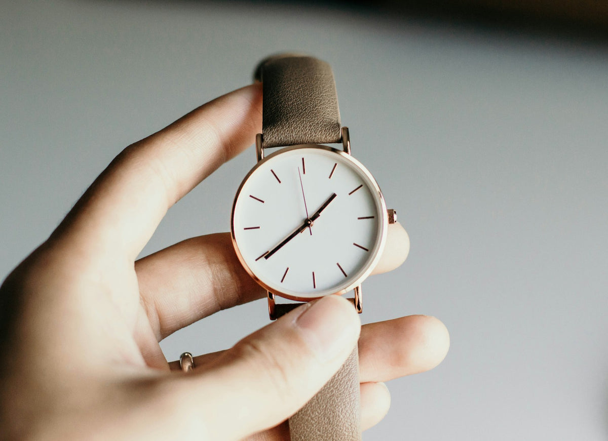 Wristwatch held in a hand