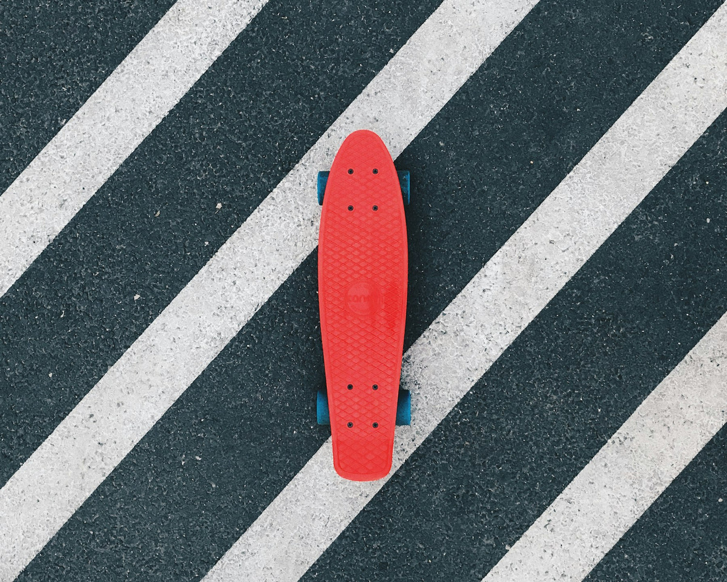 Red cruiser board on tarmac