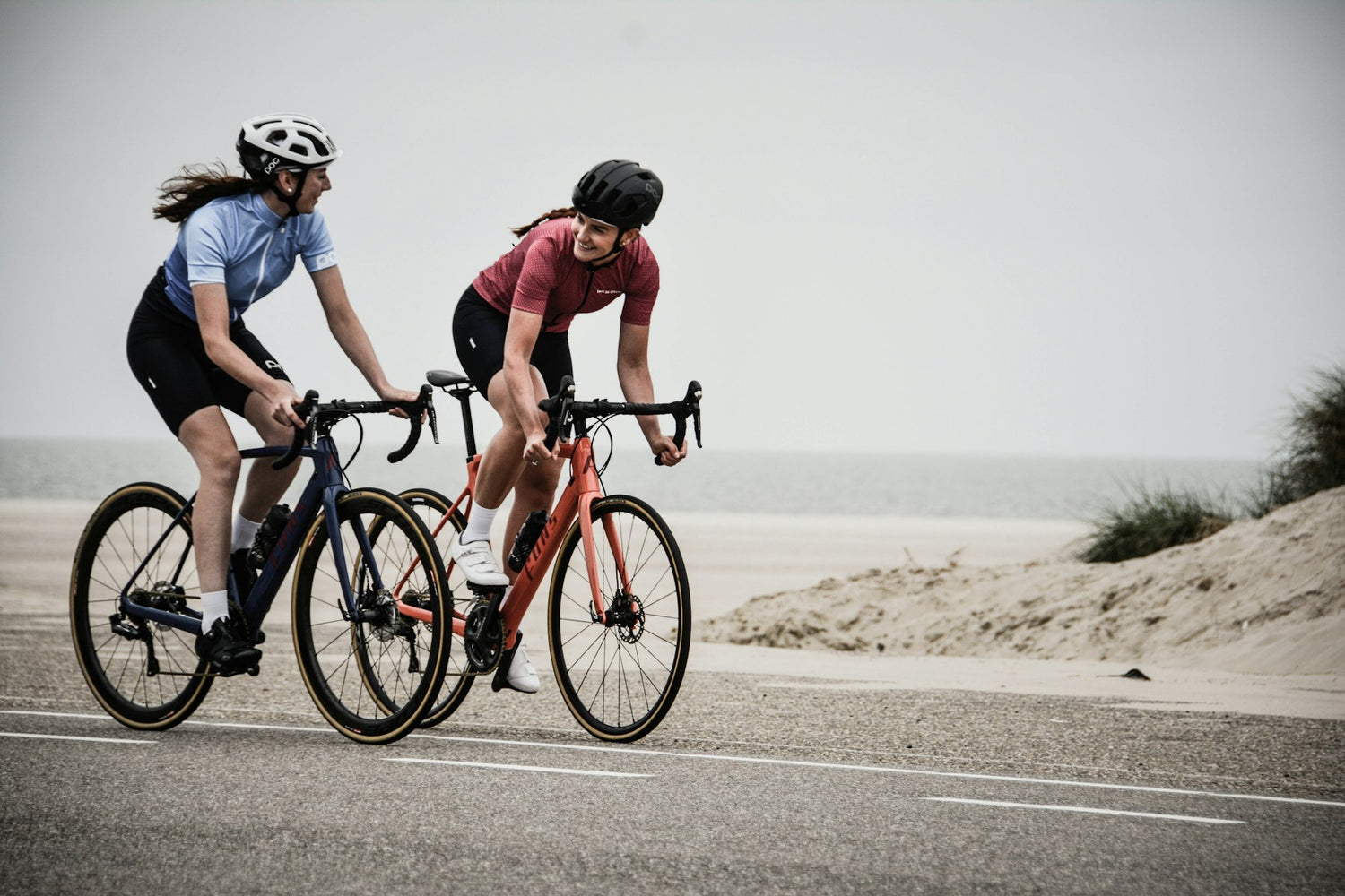 Two cyclists riding side by side