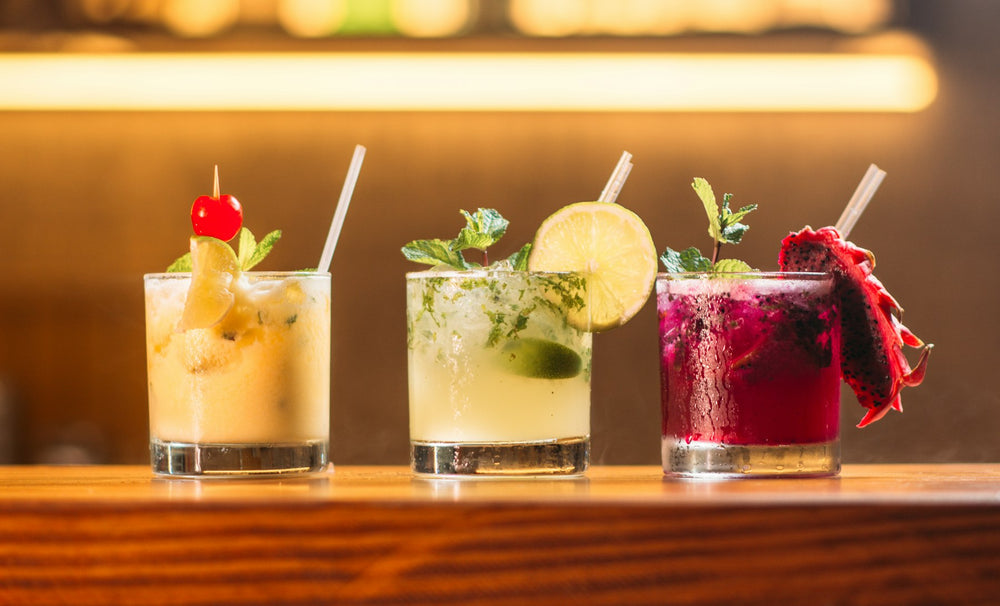Three garnished cocktails in a row