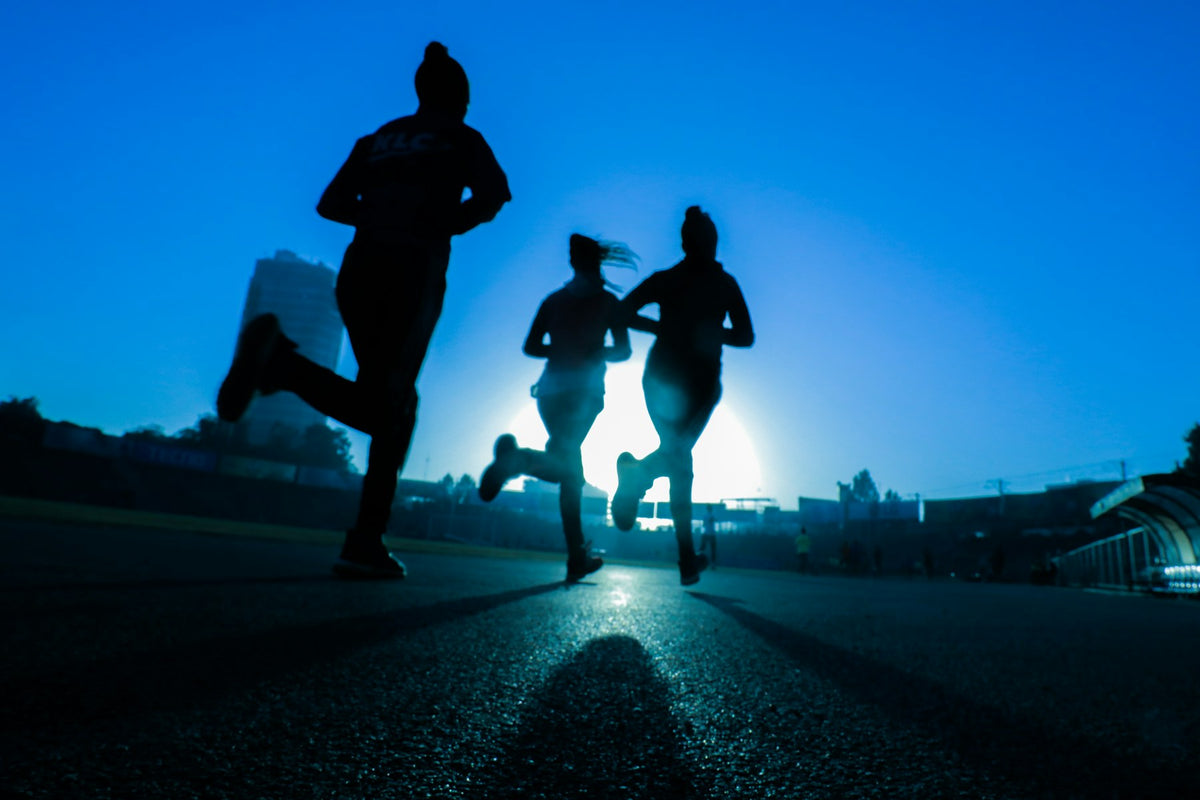 Runners silhouetted at dawn