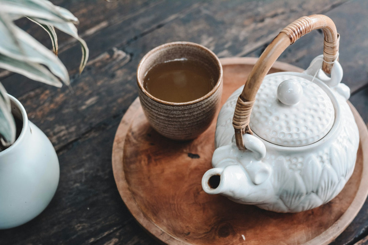 Teapot and cup on a wooden tray