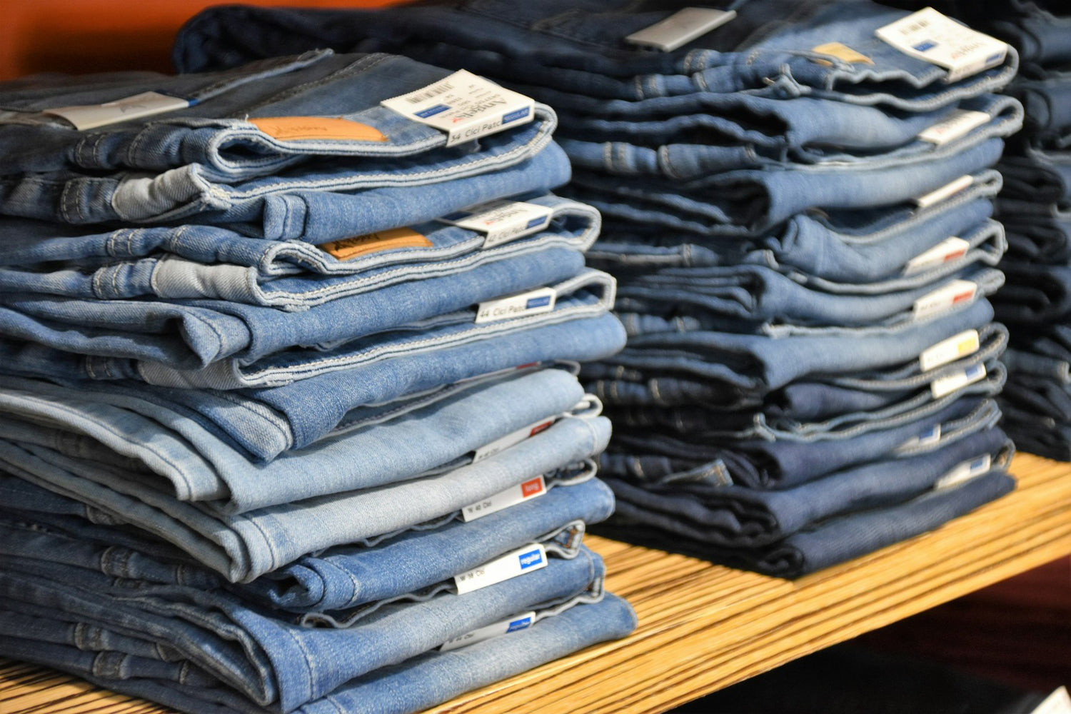 Stacks of jeans on a shop table