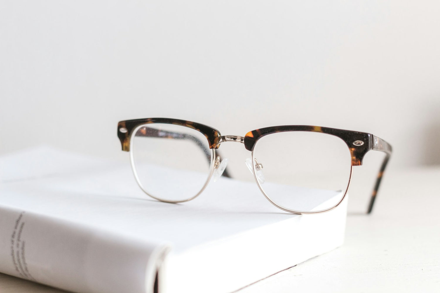 Tortoiseshell spectacles on a book