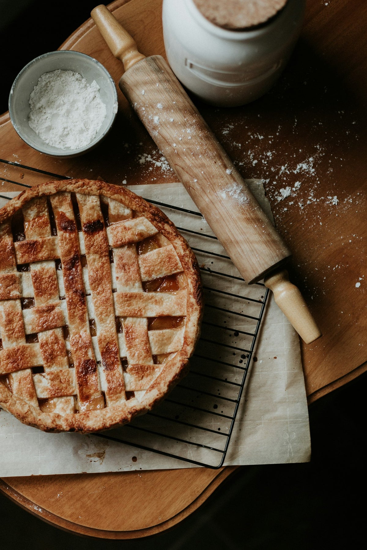 A lattice-topped apple pie cooling on a rack