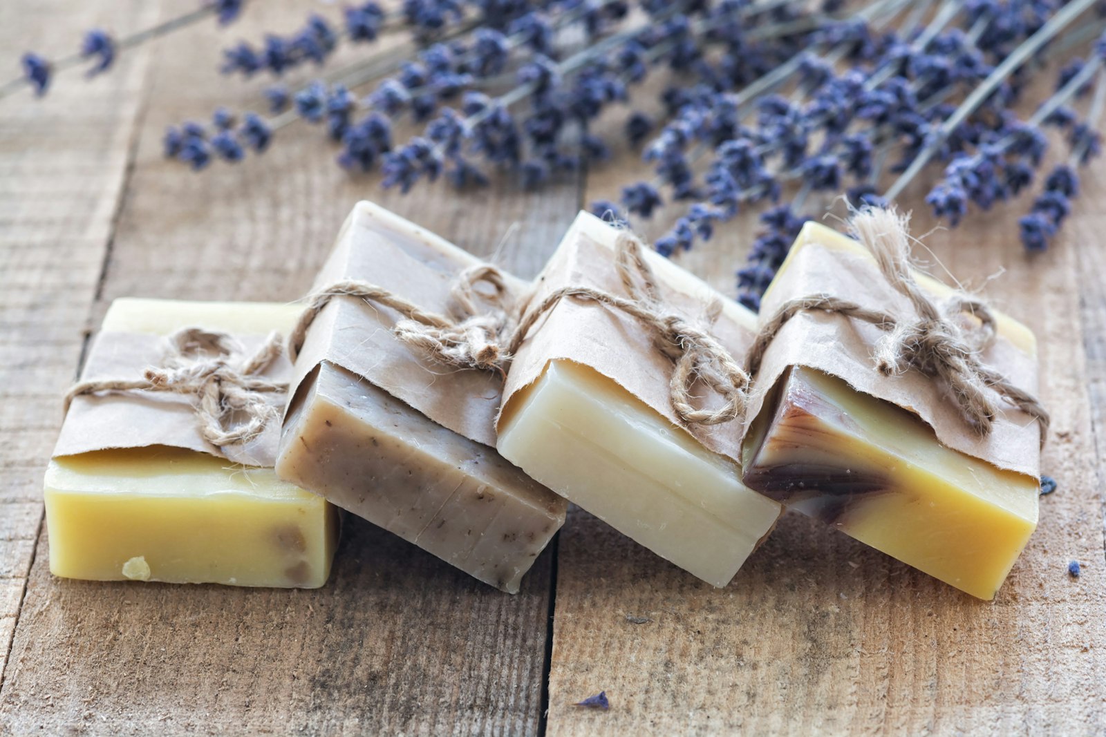 Hand-cut soap bars tied with twine beside dried lavender