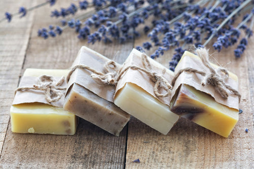 Hand-cut soap bars tied with twine beside dried lavender