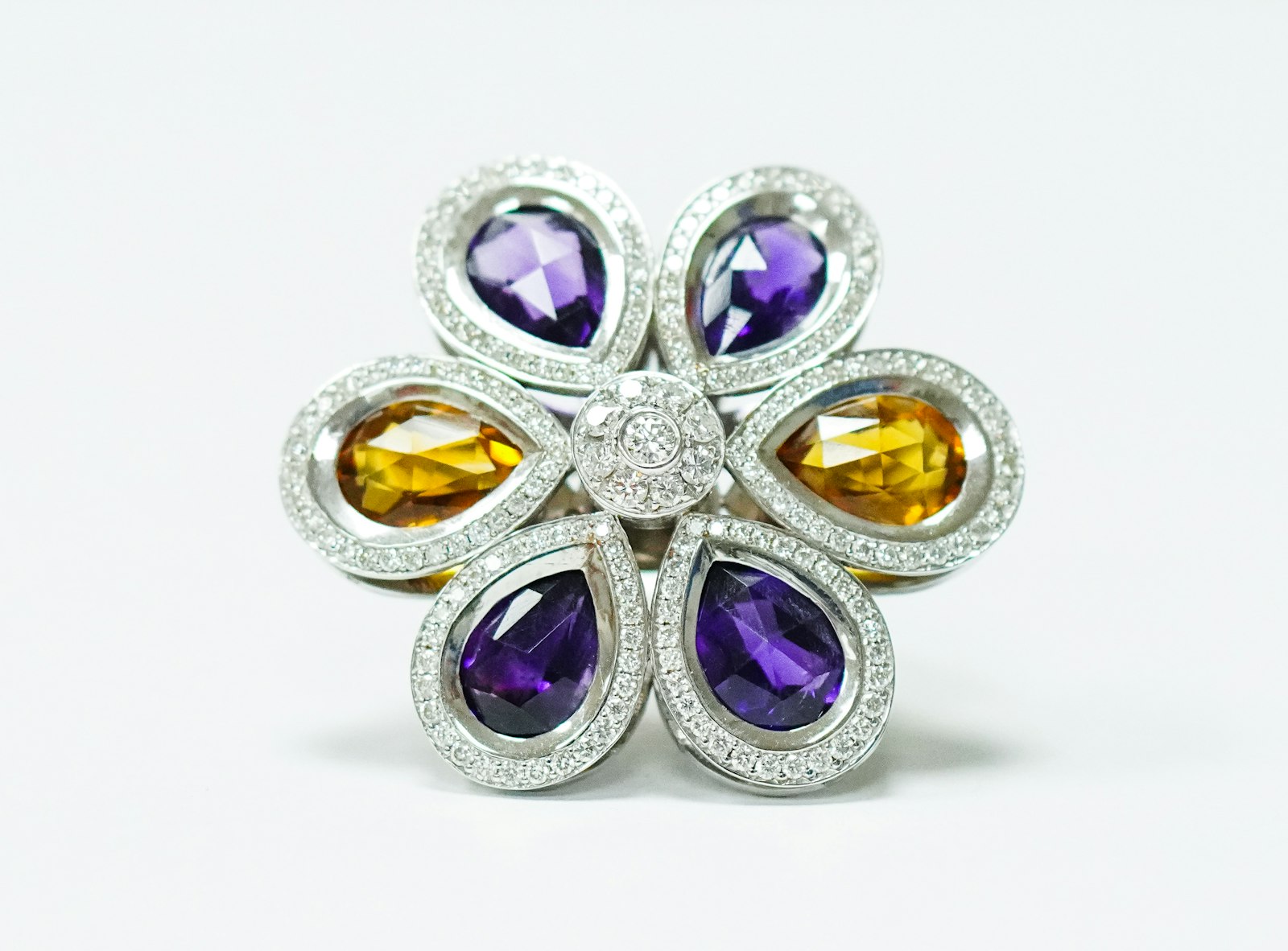 A flower-shaped cocktail ring set with amethyst and citrine