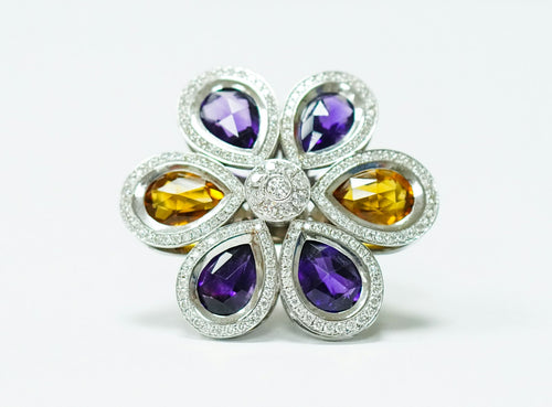 A flower-shaped cocktail ring set with amethyst and citrine