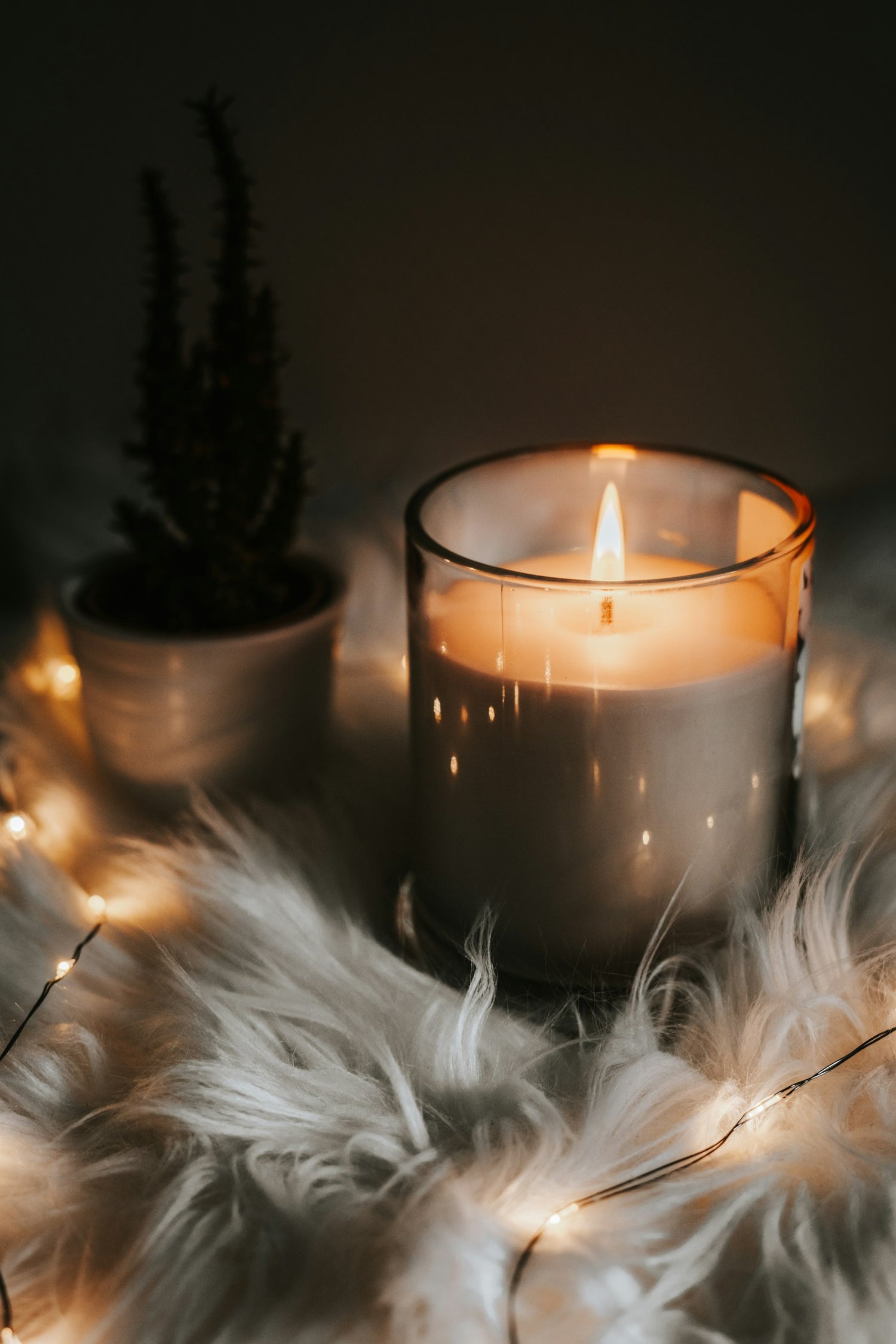 Lit candle in a glass jar