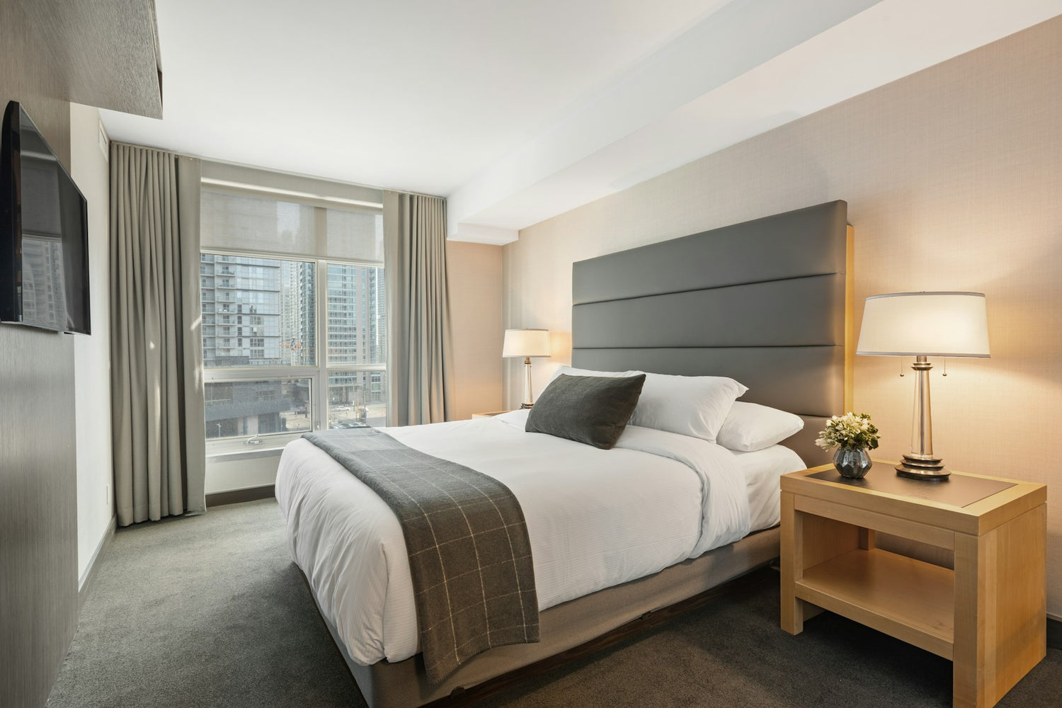 Made hotel bed with side lamps