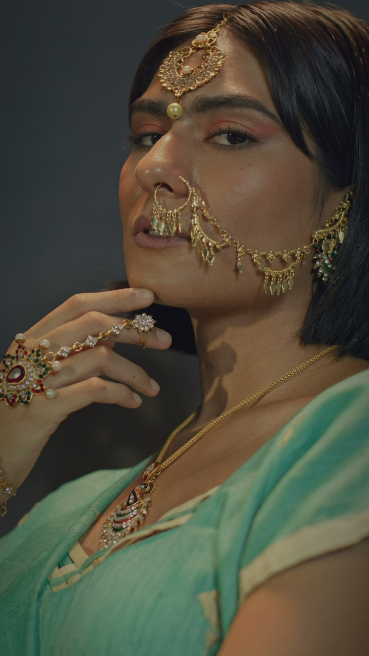 An ornate gold jewellery set worn in profile