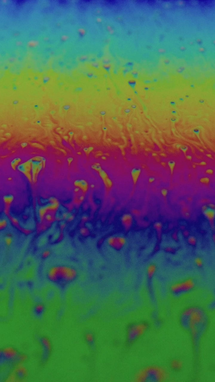 Iridescent soap film in magenta and blue