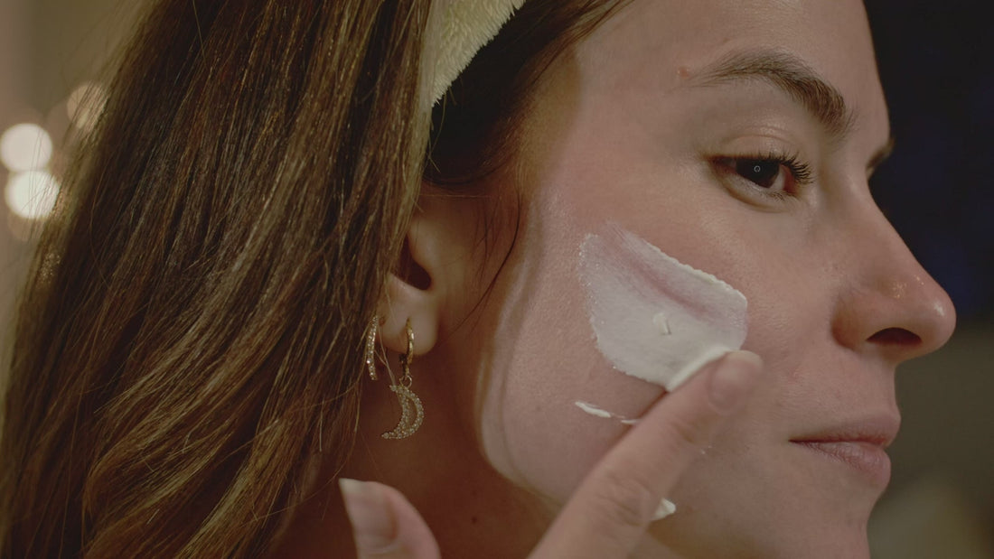 Massaging cream into the cheek in profile