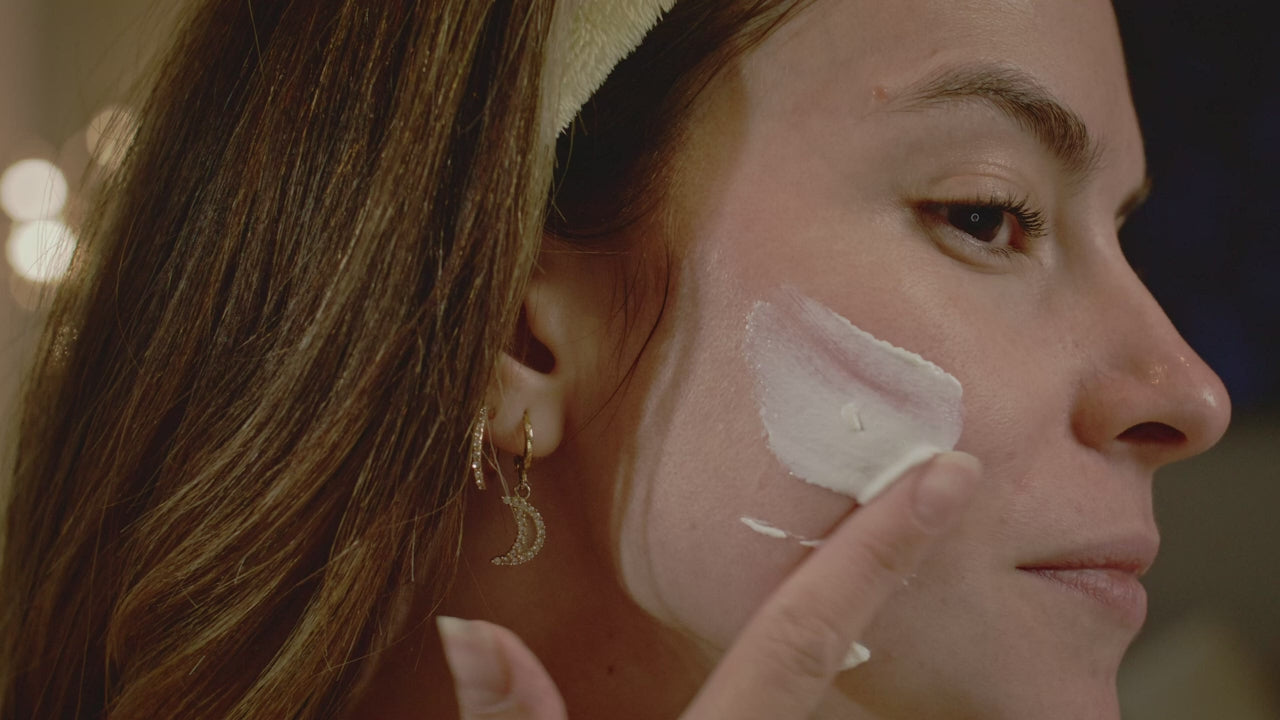 Massaging cream into the cheek in profile