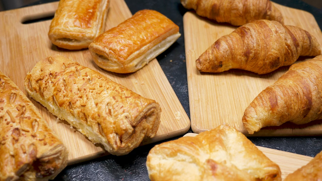 Croissants and pastries cooling on a board