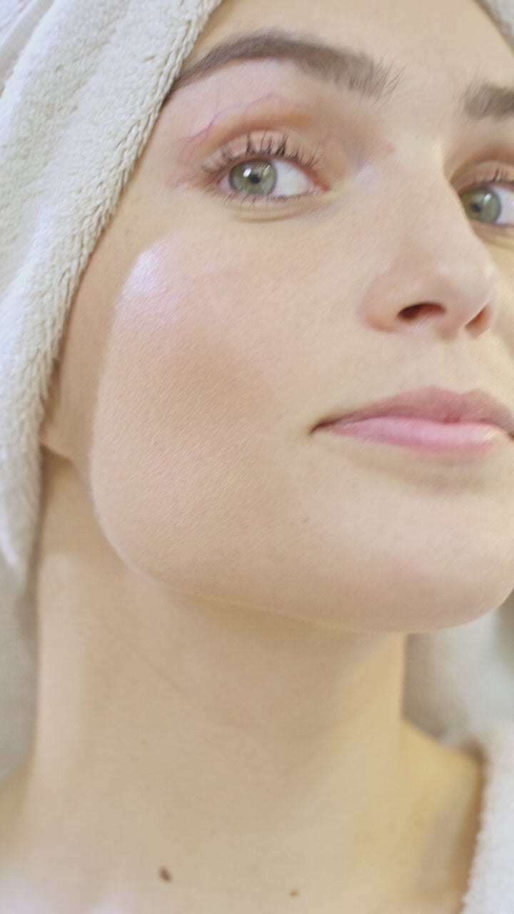 Applying eye cream with a fingertip, close up