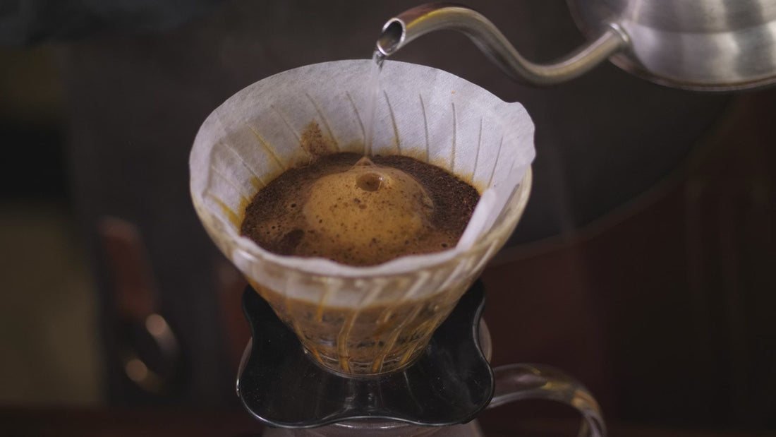 Water poured over grounds in a pour-over cone